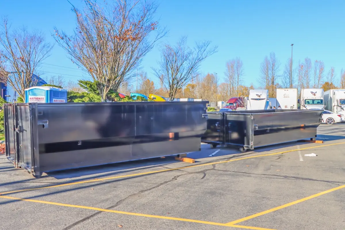 Professional dumpster rental service with roll-off container on residential driveway in Eaton Rapids